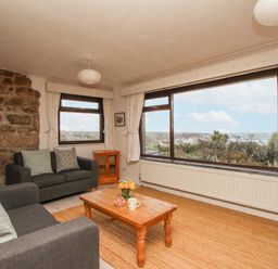 A living room with a coffee table and view at Tregiffian Vean Sennen Cove