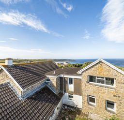 A house with a view of the ocean and landscape at Tregiffian Vean Sennen Cove