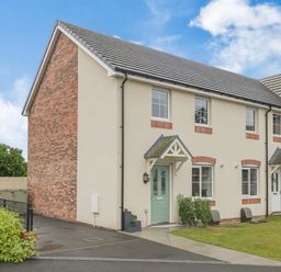 A two story semi detached house with a green door and driveway at Kymin View in Monmouth