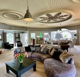 A living room with a sofa and coffee table at Capel Mawr in Llanrug near Llanberis