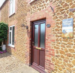 A front door with a sign at Driftwood Cottage in Heacham
