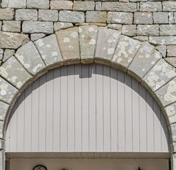 An archway made of stone blocks with a wooden panel backing at Berts Cottage in Heights near Appleby-in-Westmorland