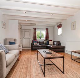 A living room with sofas and a coffee table at Wold Cottage in Hunmanby