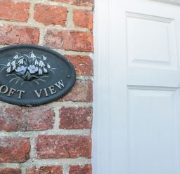 An entryway with a nameplate and door at Croft View in Fylingthorpe near Robin Hood's Bay