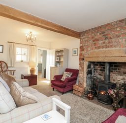 A living room with a fireplace and sofas at Croft View in Fylingthorpe near Robin Hood's Bay