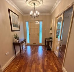 A hallway with a chandelier and a table at The Sanctuary in Killavullen near Mallow