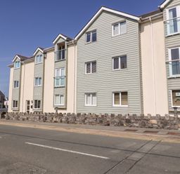 A building with multiple windows and a clock tower at Maelog, 14 Tides Reach, Rhosneigr