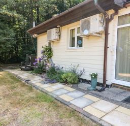 A garden path with flowers along the side of a house at Badger View in Culverstone Green near Chatham