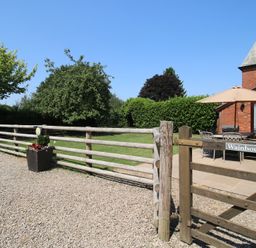An outdoor area with a table and chairs under an umbrella at The Wainhouse in Bockleton near Tenbury Wells