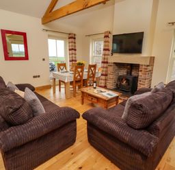 A living room with a coffee table and sofa at West Gate in Embleton