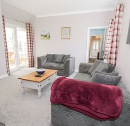 A living room with sofa and coffee table at Dyffryn Bach Glan-yr-afon near Corwen