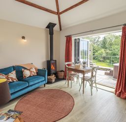 A living room with a sofa and table at Acorn in Bowness-on-Windermere