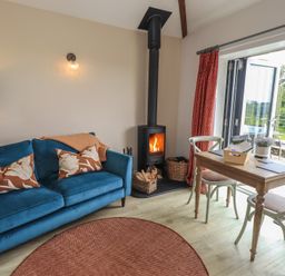 A living room with a sofa and table at Acorn in Bowness-on-Windermere