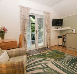 A living room with a sofa and table at Ash Lodge in Pennington near Ulverston