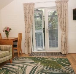A living room with a table and chairs at Ash Lodge Pennington near Ulverston