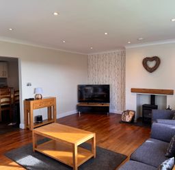 A living room with a coffee table and sofa at Rhos Helyg in Penysarn near Amlwch