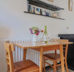 A dining room with a table and chairs at The Old Workshop in Knowstone