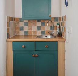 A kitchen with a sink and cabinet at The Old Workshop in Knowstone