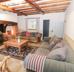 A living room with a fireplace and sofas at Town Mill in Bewdley