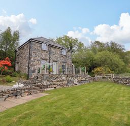 A house with garden and stone wall at Moelfre Cottage Llanbedr