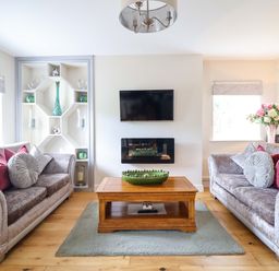 A living room with sofas and a coffee table at Moelfre Cottage Llanbedr