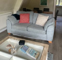 A living room with a sofa and a coffee table at Lodge 22, Bodmin Holiday Park, Cornwall Lanevet