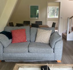 A living room featuring a sofa and dining area at Lodge 22, Bodmin Holiday Park, Cornwall, Lanivet
