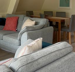 A living room with sofas and a dining area at Lodge 22, Bodmin Holiday Park, Cornwall