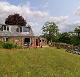 A house with gardens and trees at Mallows Byre in Yetminster