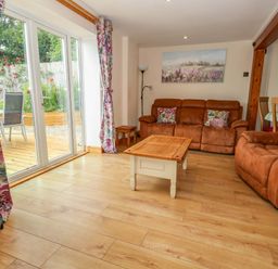 A living room with sofas and a coffee table at Mallows Byre in Yetminster