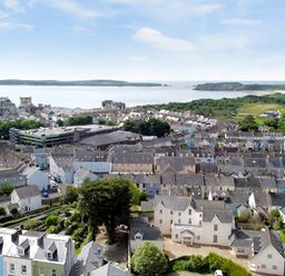 An aerial view of a coastal town with houses parks and water at Harbour Beach at The Hideaway in Tenby