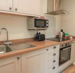 A kitchen with a sink and various appliances at The Cider Press, Motcombe