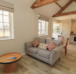 A living room with a sofa and coffee table at The Apple Shed, Motcombe, Shaftesbury