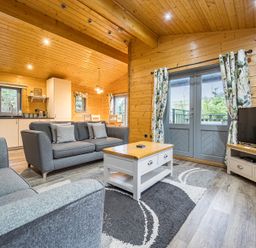 A living room with a sofa and coffee table at Elm Lodge in Ulverston