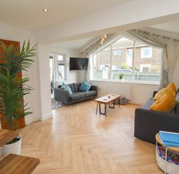 A living room with sofas and a coffee table at Sunrise Cottage Beadnell