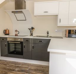 A kitchen with an oven stove microwave kettle utensils and a sink at Squirrels Drey in Little Dunham near Litcham