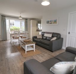 A living room with sofas coffee table dining table and chairs at Flip Flops in The Bay near Filey