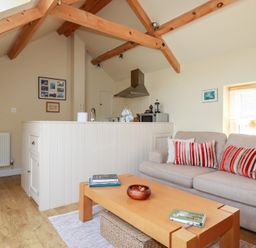 A living room with a sofa and coffee table at Mithian Cottage in St Agnes