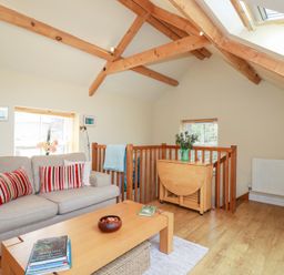 A living room with a sofa and coffee table at Mithian Cottage in St Agnes