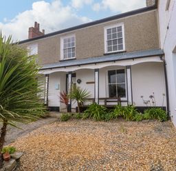 A house exterior with plants and gravel path at 1 Dormer Villas Portscatho