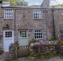 Two stone cottages with doors and windows at May Cottage Pentewan