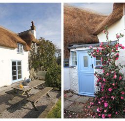 A thatched cottage with blue doors and windows surrounded by flowers and outdoor seating at Rose Cottage in Manaccan