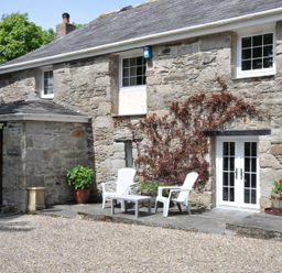 An outdoor area with chairs and planters at Trevenning Barn near Port Isaac