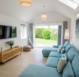 A living room with a sofa and television at Lanesend in St Agnes