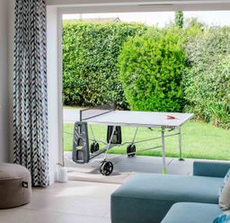 A living room with a table tennis table and sofa at Lanesend in St Agnes
