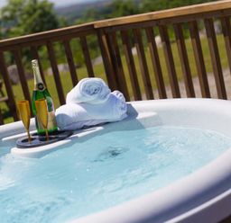 A hot tub with towels and champagne at Costentyn, Tor Down Quarry St Breward