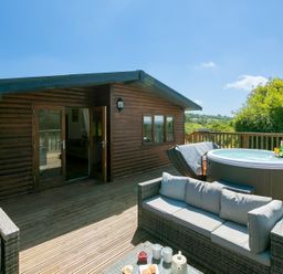 An outdoor area with a hot tub and seating at Costentyn, Tor Down Quarry St Breward