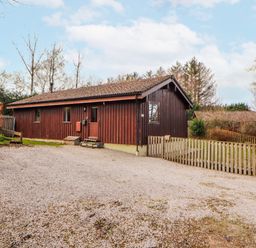 A wooden house with a gravel front yard at 26 Dukes Meadow in Greystoke near Penrith