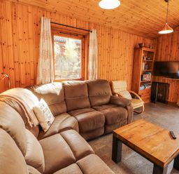 A living room with a sofa and television at 26 Dukes Meadow in Greystoke near Penrith