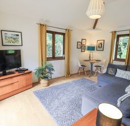 A living room with a television and a sofa at Doe Foot Cottage Ingleton